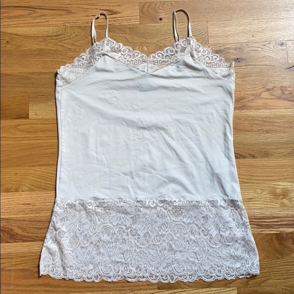 Cream lace tank with adjustable straps.